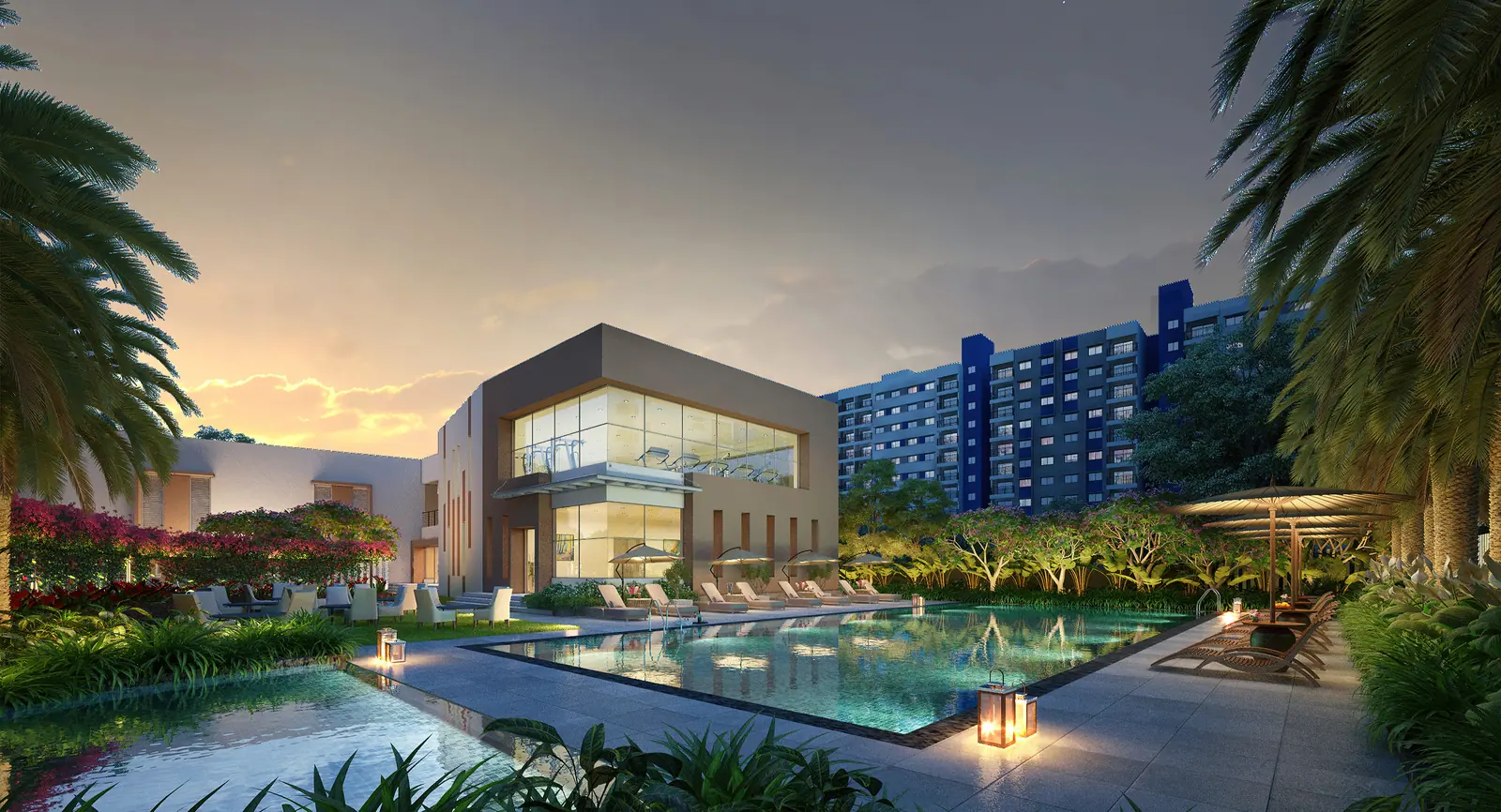 Clubhouse and pool deck at dusk at Adarsh Tropica